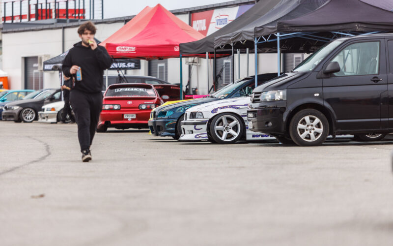 BMW E36 driftiautod ja punane Toyota Soarer Lexus SC tiimitelkide all Porsche Ringi boksiteel Augustfest 2026 festivalil