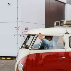Punase ja beeži värvikombinatsioonis klassikaline Volkswagen T1 buss avatava safariklaasiga ja lehvitava juhiga Pärnu Porsche Ringil Augustfest 2026 festivalil