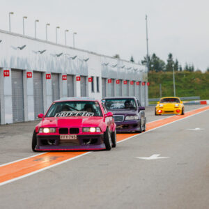 Roosa BMW E36 driftiauto ja teised võistlusautod reas Pärnu Porsche Ringi boksiteel Augustfest 2026 festivalil